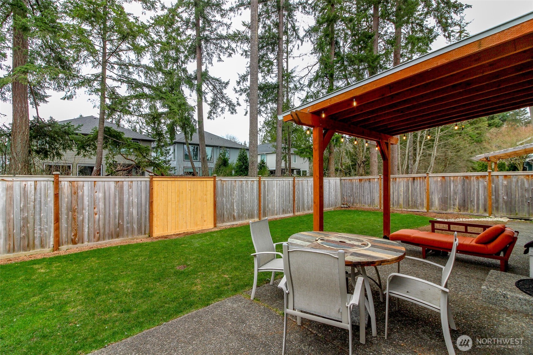 23425 Southeast 248th Street Maple Valley, WA 98038 - Photo 31 of 40 a view of backyard with table and chairs with wooden floor and fence