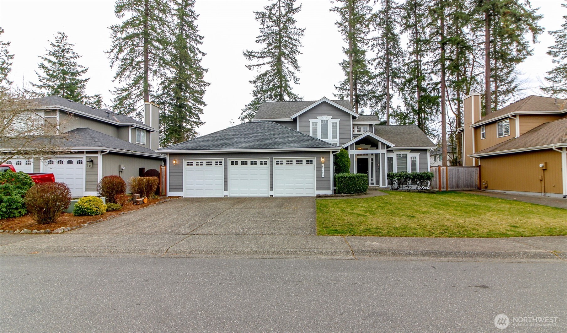 23425 Southeast 248th Street Maple Valley, WA 98038 - Photo 35 of 40 a front view of a house with a garden and trees