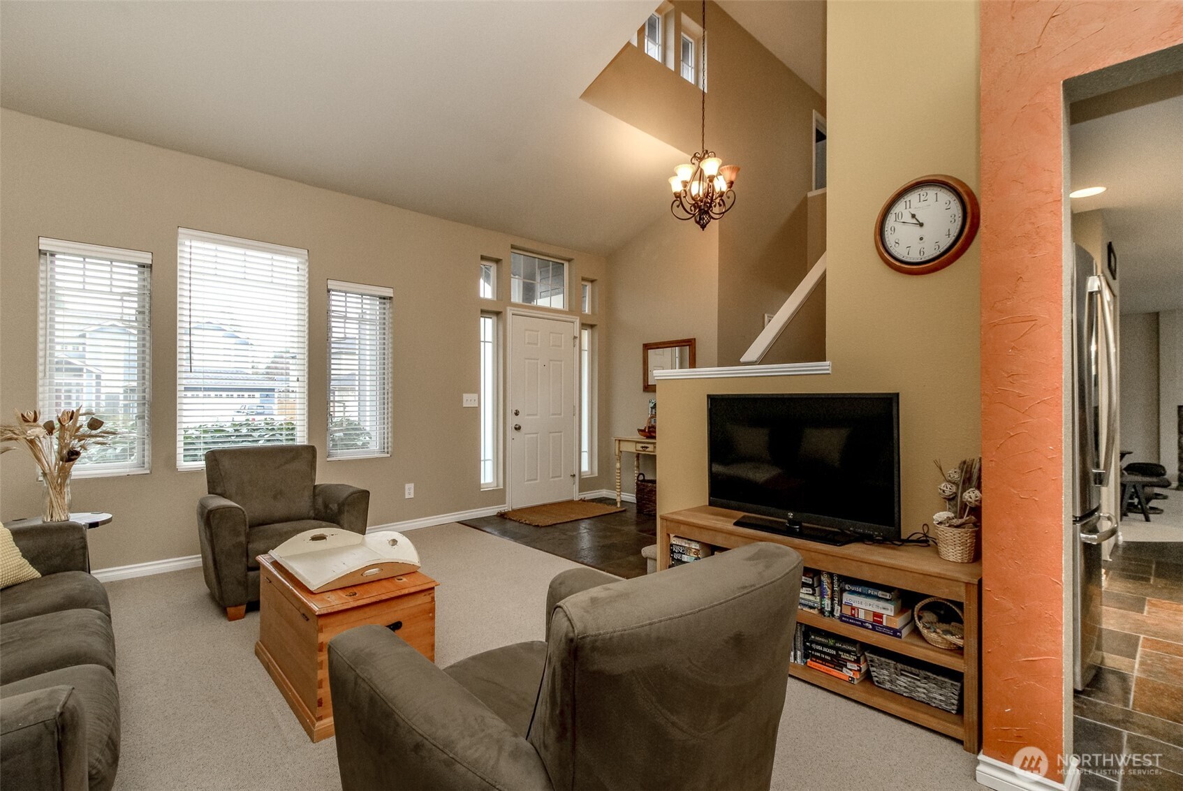 23425 Southeast 248th Street Maple Valley, WA 98038 - Photo 7 of 40 a living room with furniture a fireplace and a flat screen tv