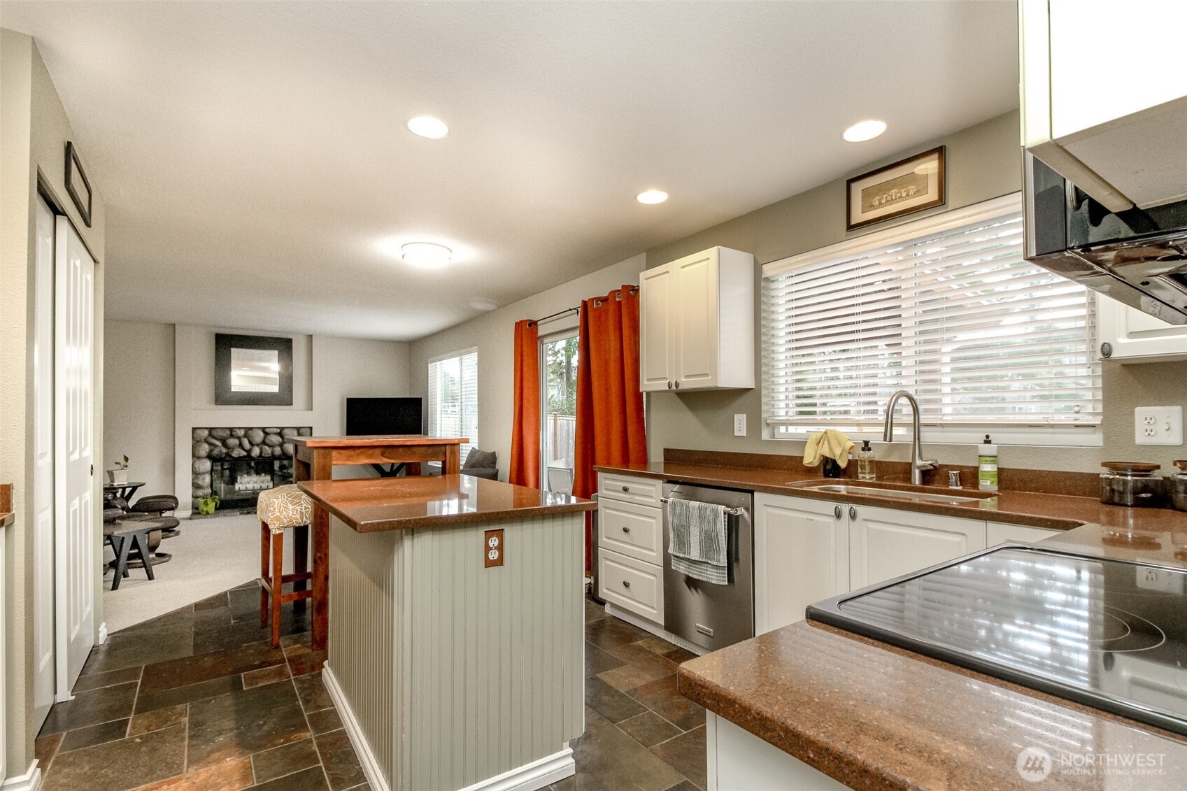 23425 Southeast 248th Street Maple Valley, WA 98038 - Photo 10 of 40 a kitchen with stainless steel appliances granite countertop sink stove top oven and cabinets