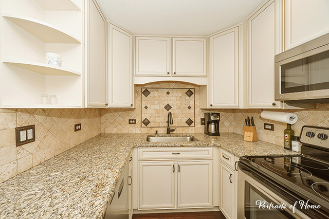 1900 Light Road, Unit 102 Oswego, IL 60543 - Photo 3 of 10 a kitchen with stainless steel appliances granite countertop a stove a sink and a microwave