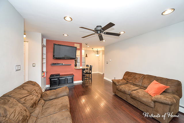 1900 Light Road, Unit 102 Oswego, IL 60543 - Photo 5 of 10 a living room with furniture and a flat screen tv