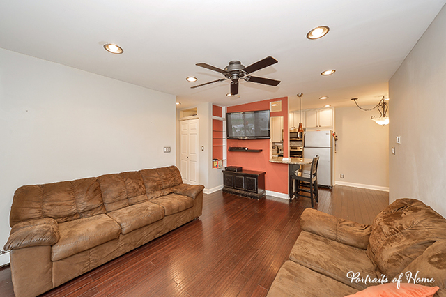 1900 Light Road, Unit 102 Oswego, IL 60543 - Photo 6 of 10 a living room with furniture and a chandelier