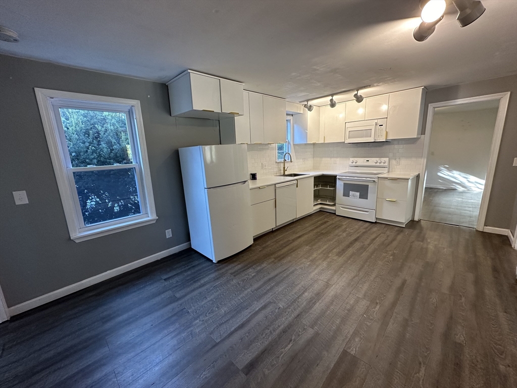 8 Pike Street Hopkinton, MA 01748 - Photo 10 of 34 a kitchen with a white stove top oven and sink