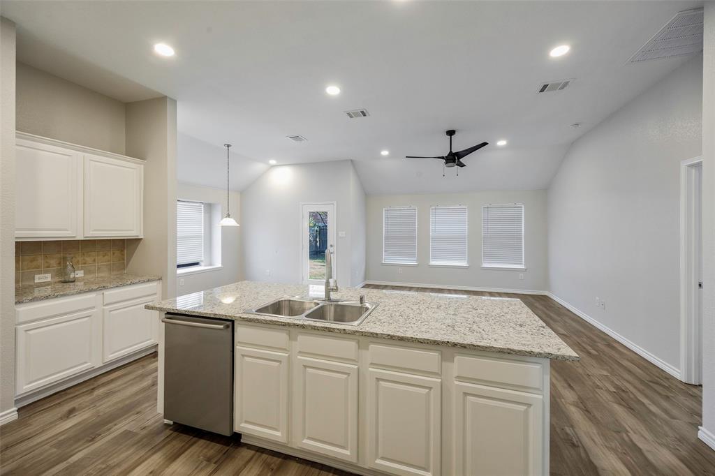 3603 Cottonwood Road Melissa, TX 75454 - Photo 6 of 27 Kitchen with vaulted ceiling, white cabinetry, tasteful backsplash, light stone counters, and recessed lighting