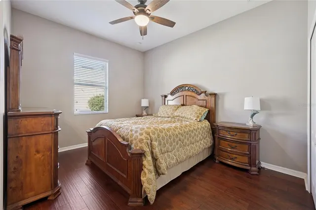 a en suite bathroom with a granite countertop sink and a mirror