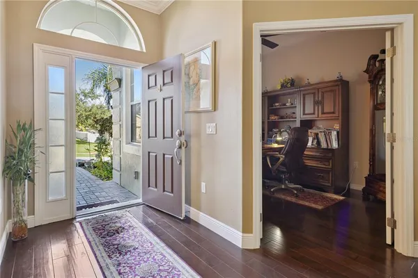 a living room with furniture chess board and wooden floor