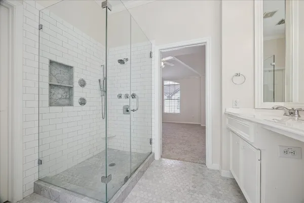 a bathroom with a shower and a sink