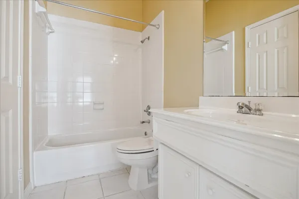 a bathroom with a bathtub shower sink vanity and toilet