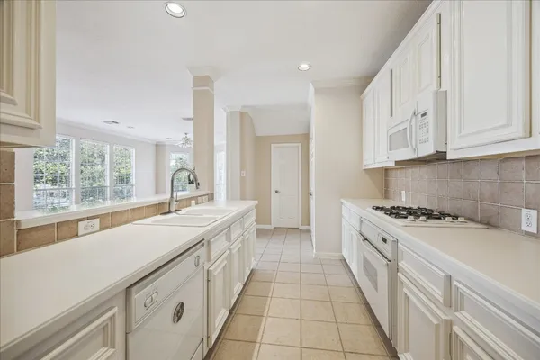 a kitchen with a sink stove and cabinets