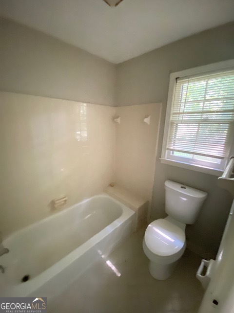 203 Farmbrook Parkway Stockbridge, GA 30281 - Photo 13 of 25 a white toilet sitting next to a bath tub