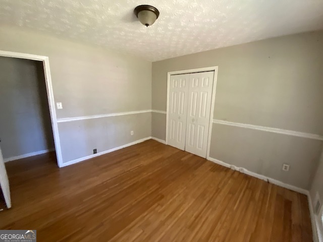 203 Farmbrook Parkway Stockbridge, GA 30281 - Photo 16 of 25 an empty room with wooden floor and windows