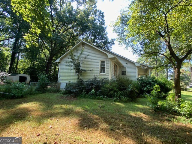 203 Farmbrook Parkway Stockbridge, GA 30281 - Photo 23 of 25 a view of a backyard with plants and large trees