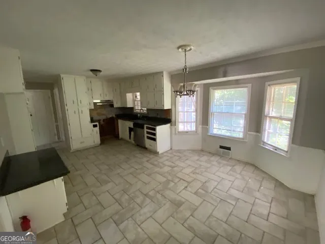 a view of a kitchen with furniture and a window