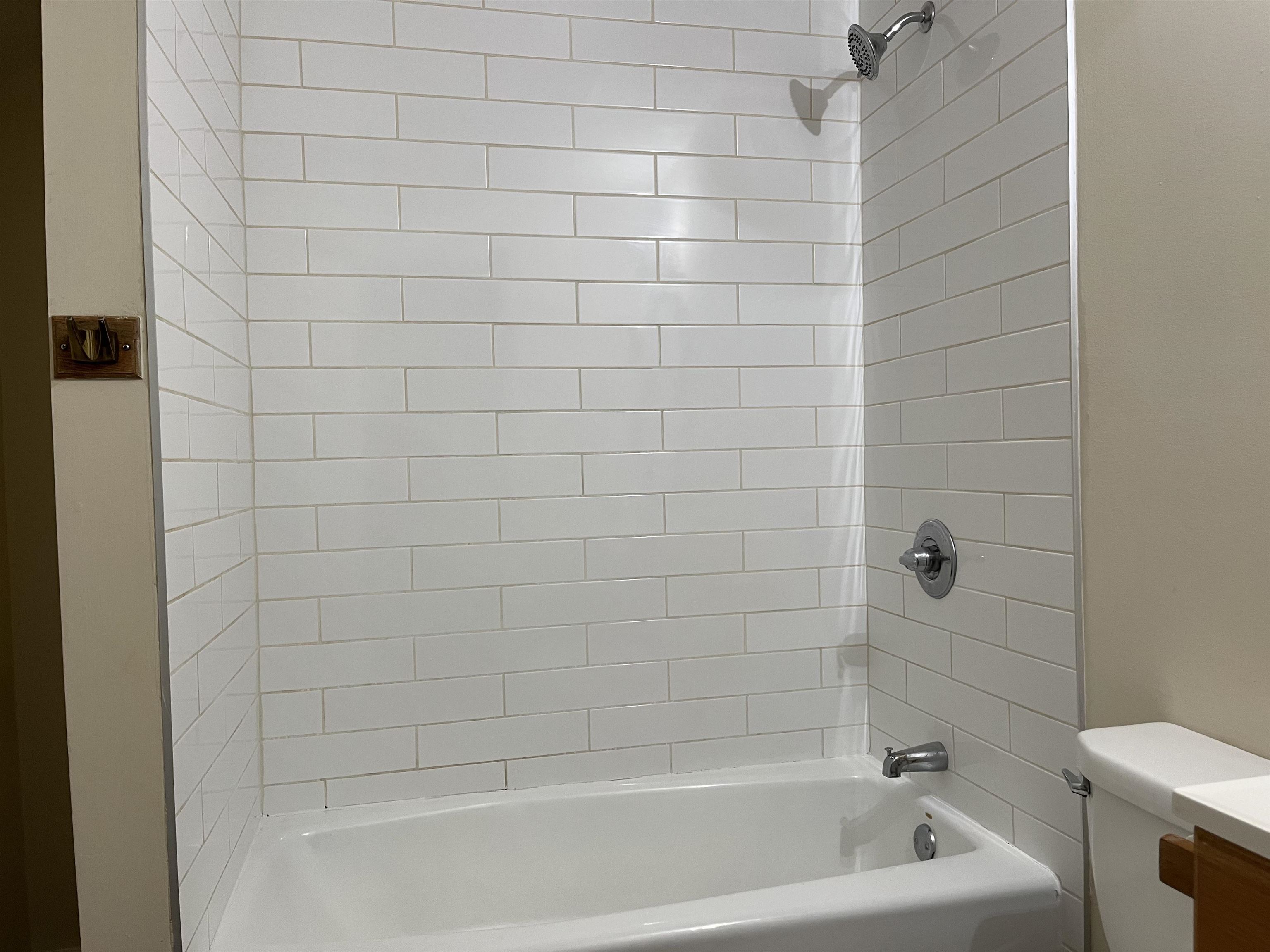 138 King Street, Unit C St. Augustine, FL 32084 - Photo 11 of 17 a bathroom with a bathtub