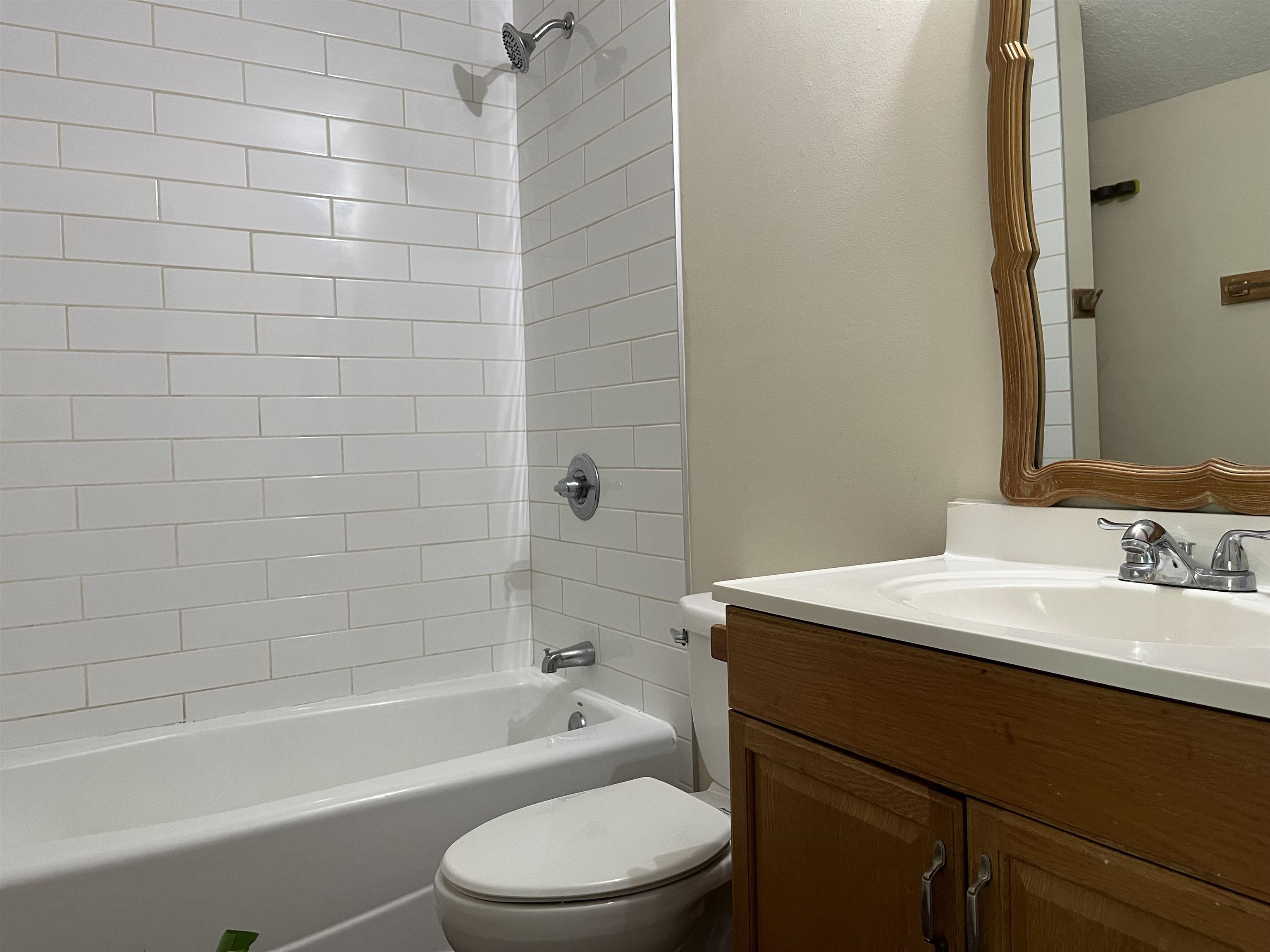 138 King Street, Unit C St. Augustine, FL 32084 - Photo 12 of 17 a bathroom with a sink a toilet a mirror and shower