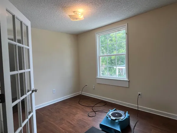 a room with wooden floor and window