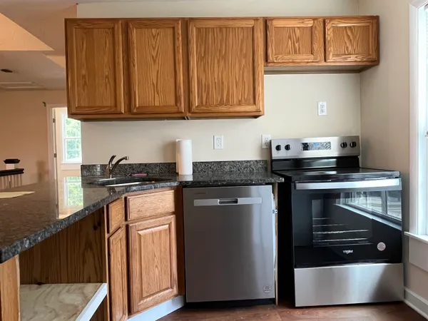 a kitchen with stainless steel appliances granite countertop a stove and a microwave