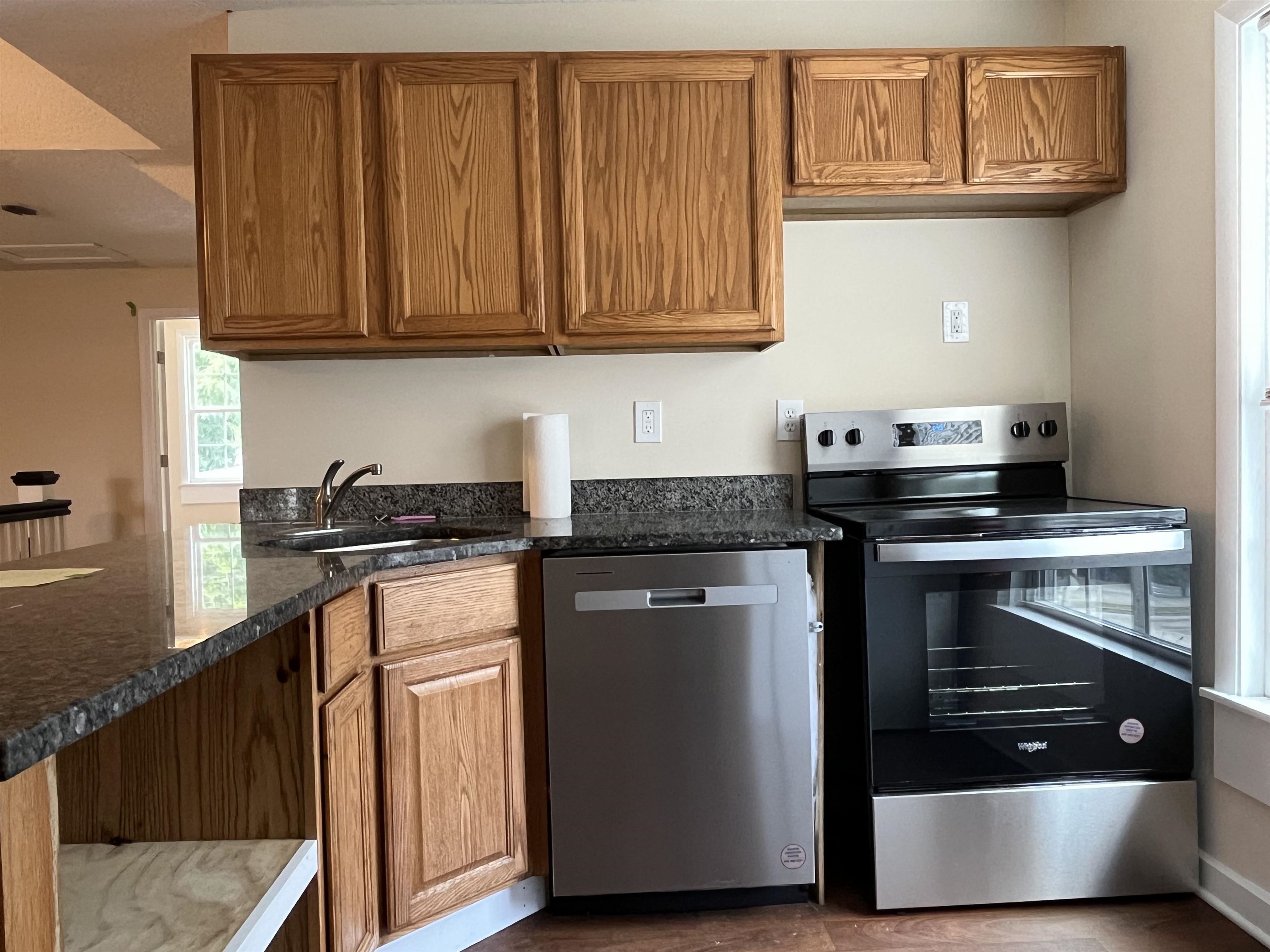 138 King Street, Unit C St. Augustine, FL 32084 - Photo 5 of 17 a kitchen with stainless steel appliances granite countertop a stove and a microwave