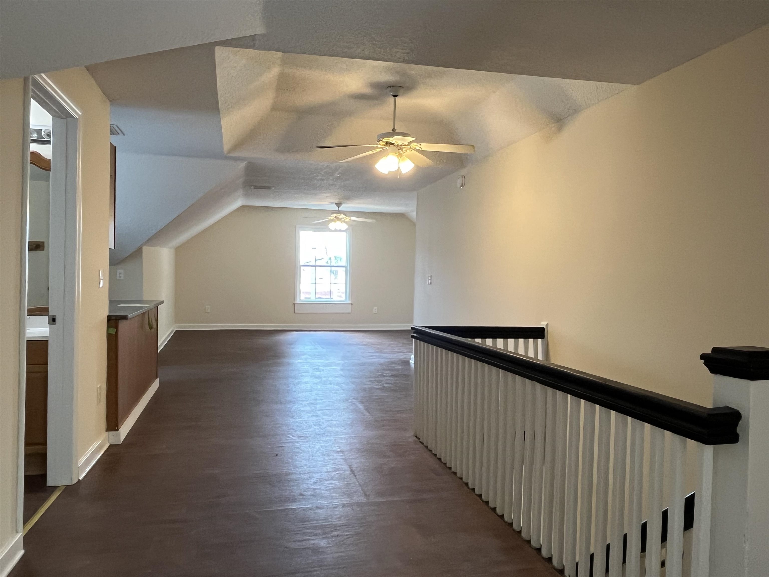 138 King Street, Unit C St. Augustine, FL 32084 - Photo 7 of 17 a view of a hallway with wooden floor and staircase