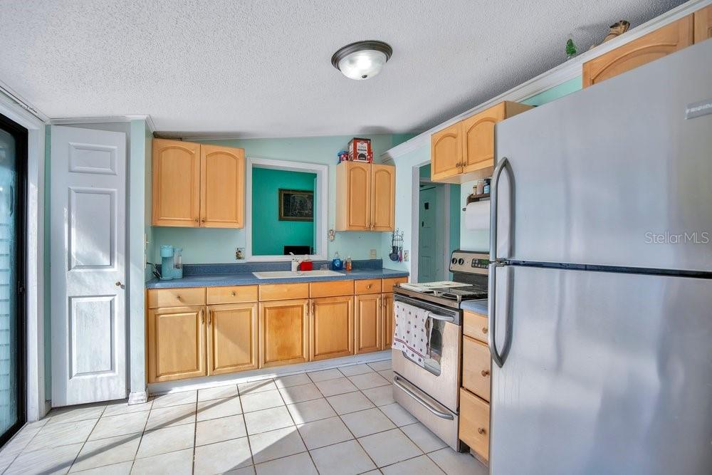 425 Scooter Point Geneva, FL 32732 - Photo 14 of 41 a kitchen with stainless steel appliances a refrigerator sink and cabinets