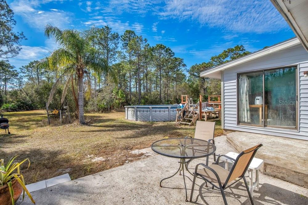 425 Scooter Point Geneva, FL 32732 - Photo 27 of 41 a patio with a table and chairs and potted plants