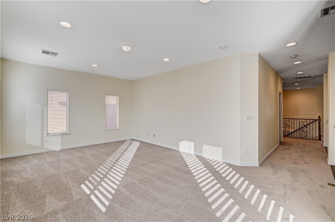 6761 Clay TABLET Street Las Vegas, NV 89149 - Photo 51 of 73 Recessed lighting and soft carpeting create a warm atmosphere in this versatile upper-level bonus space.