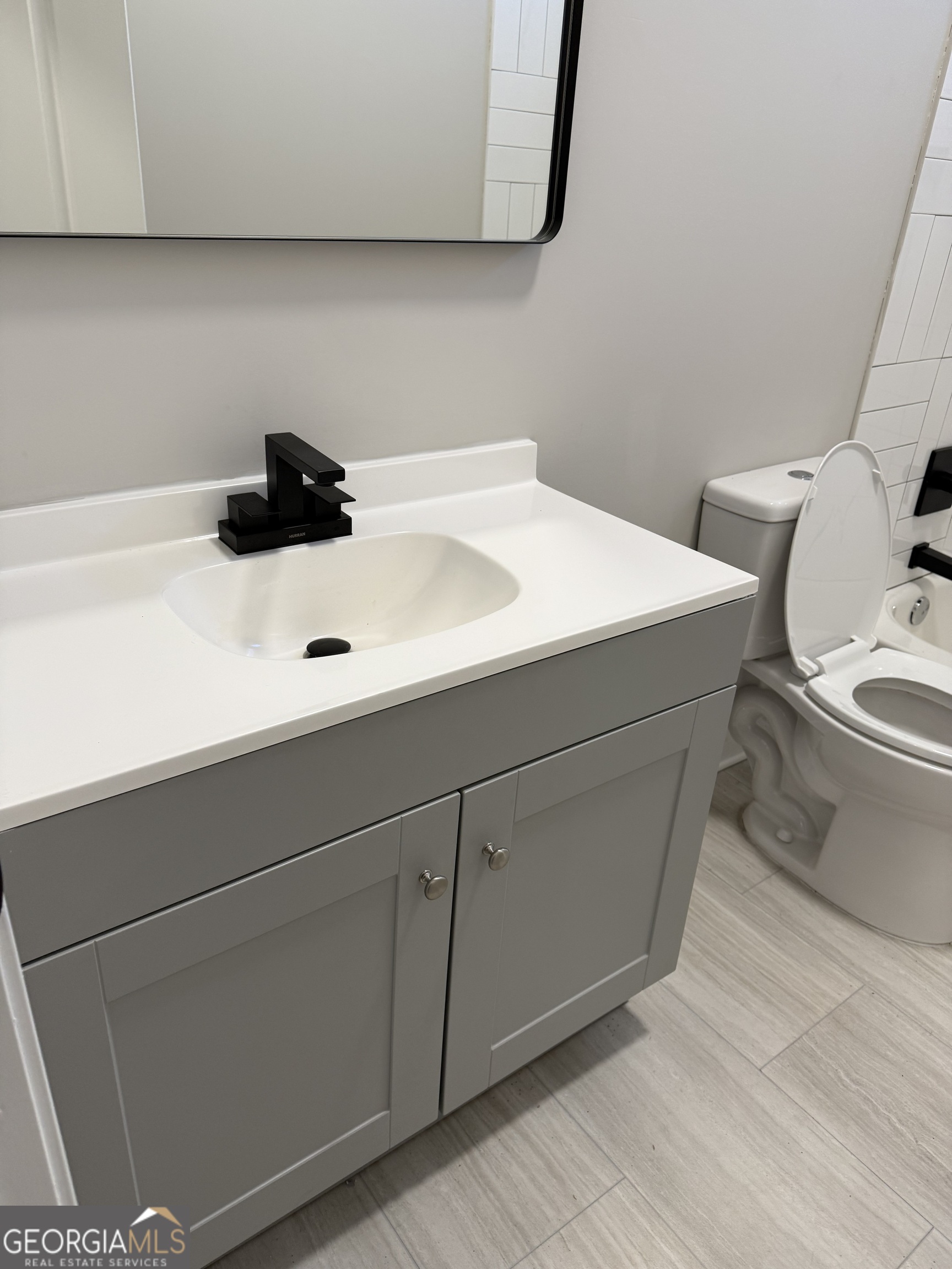 2 Cedar Avenue Griffin, GA 30223 - Photo 7 of 13 a bathroom with a sink and a toilet