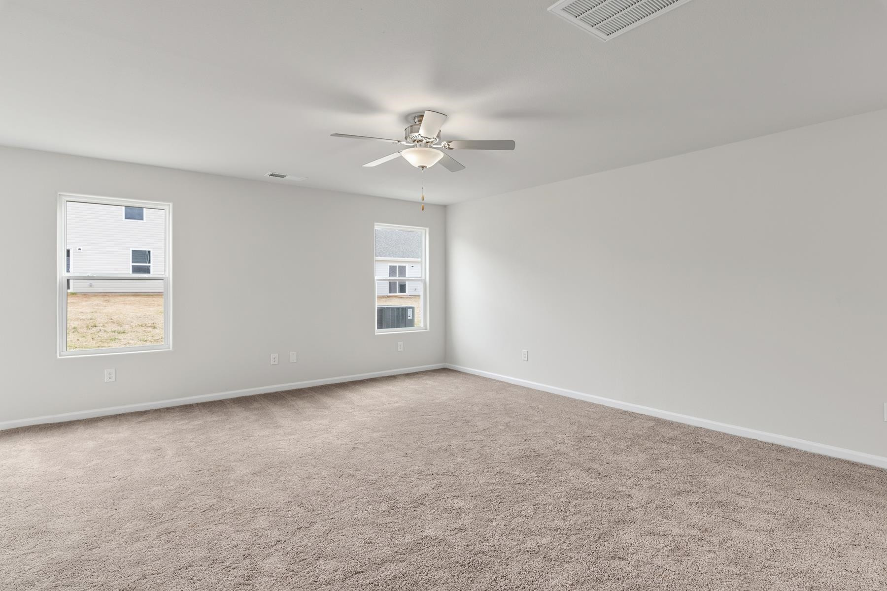 310 Crooked Row Lane Roxboro, NC 27574 - Photo 4 of 11 an empty room with windows and fan