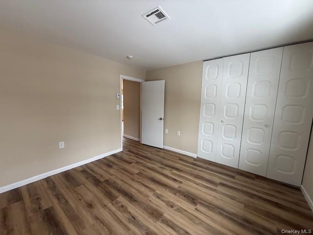 373 Woodbridge Drive, Unit B Ridge, NY 11961 - Photo 14 of 23 a view of an empty room and wooden floor