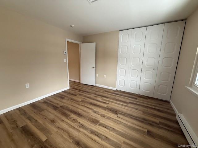 373 Woodbridge Drive, Unit B Ridge, NY 11961 - Photo 16 of 23 a view of an empty room with wooden floor and a window