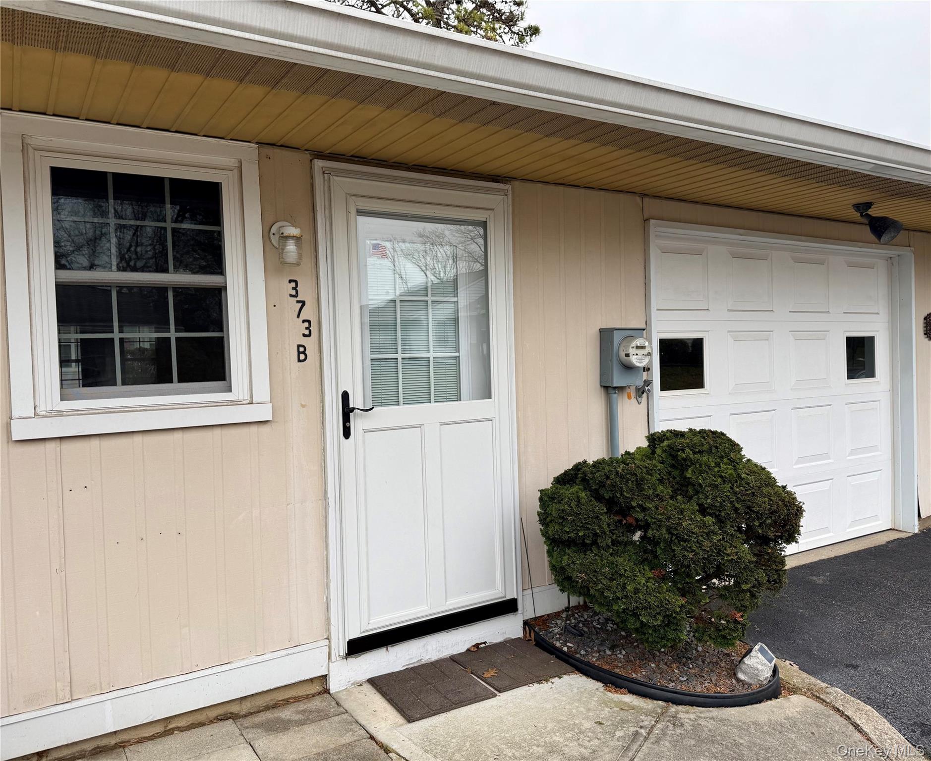 373 Woodbridge Drive, Unit B Ridge, NY 11961 - Photo 2 of 23 a view of a entryway door of the house