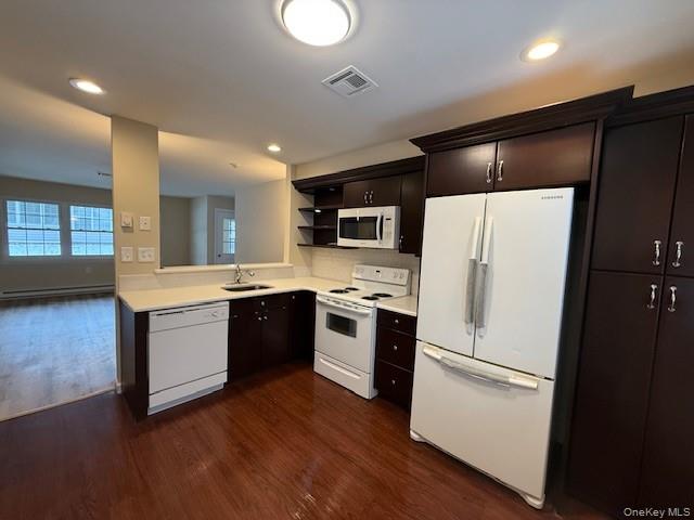 373 Woodbridge Drive, Unit B Ridge, NY 11961 - Photo 6 of 25 Kitchen with white appliances, light countertops, dark wood-style Cabinets, Updated flooring, open shelves, and recessed lighting