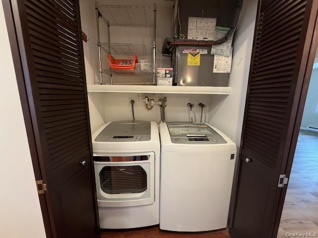 373 Woodbridge Drive, Unit B Ridge, NY 11961 - Photo 7 of 25 Washroom with Newer Washing Machine and Dryer and Wood Finished Floors