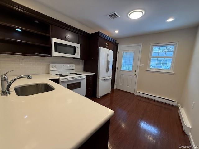 373 Woodbridge Drive, Unit B Ridge, NY 11961 - Photo 9 of 23 a kitchen with stainless steel appliances a stove a microwave a sink a refrigerator and cabinets