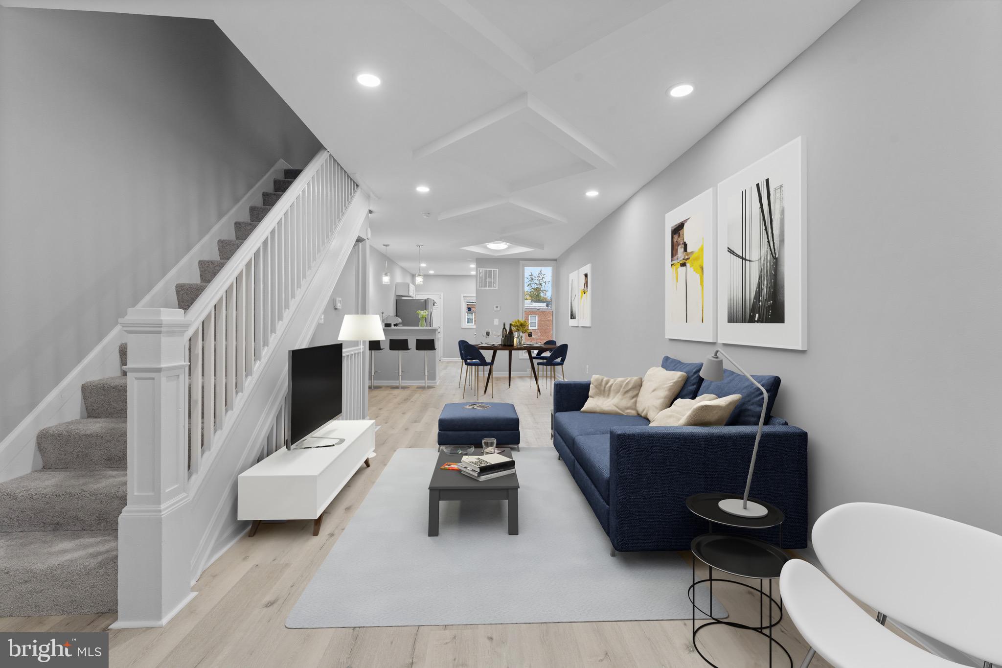 a living room with furniture a rug and white walls