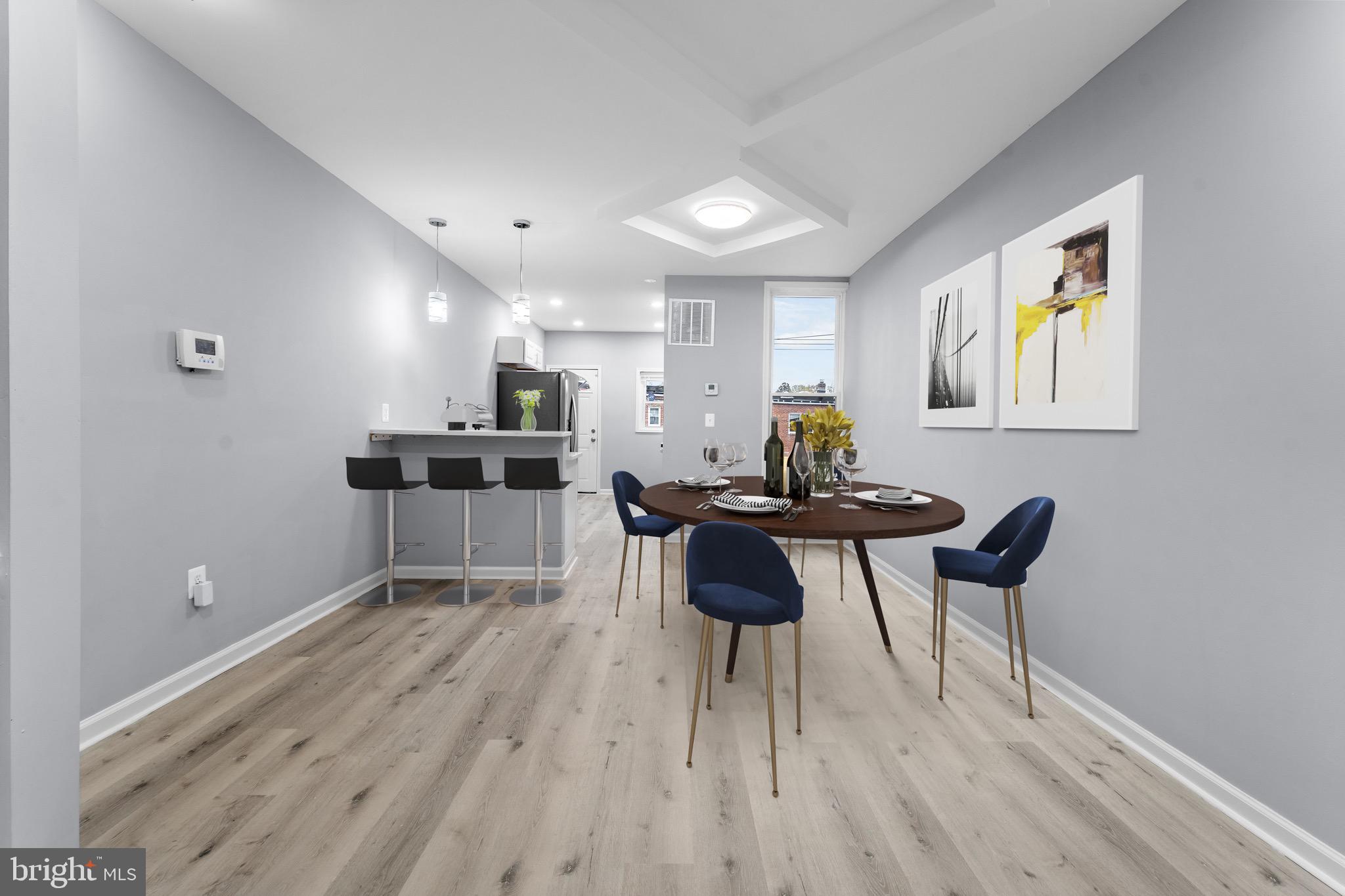 3904 Woodridge Road Baltimore, MD 21229 - Photo 5 of 17 a kitchen with stainless steel appliances a table and chairs in it