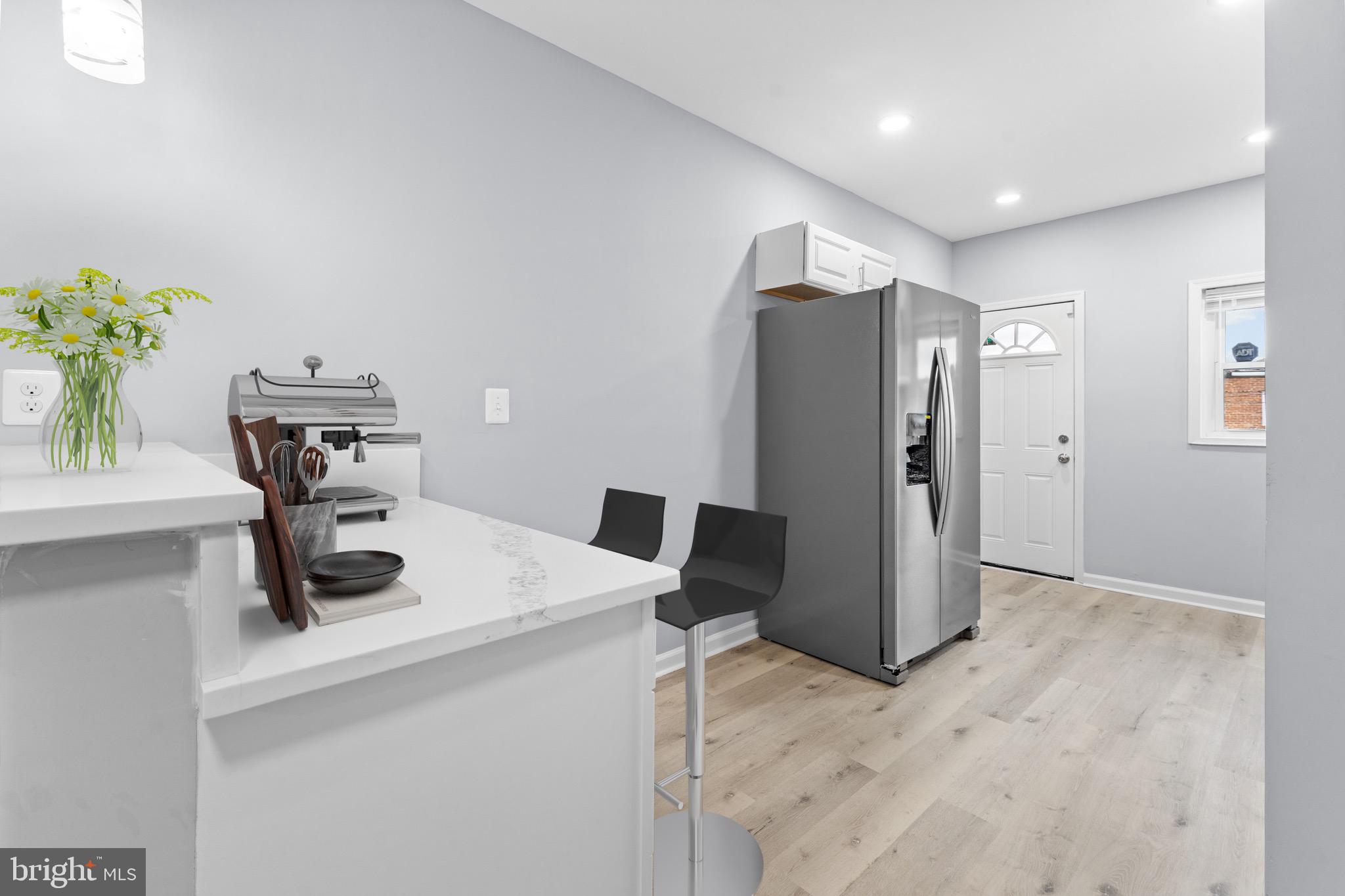 3904 Woodridge Road Baltimore, MD 21229 - Photo 6 of 17 a kitchen with a refrigerator and a sink