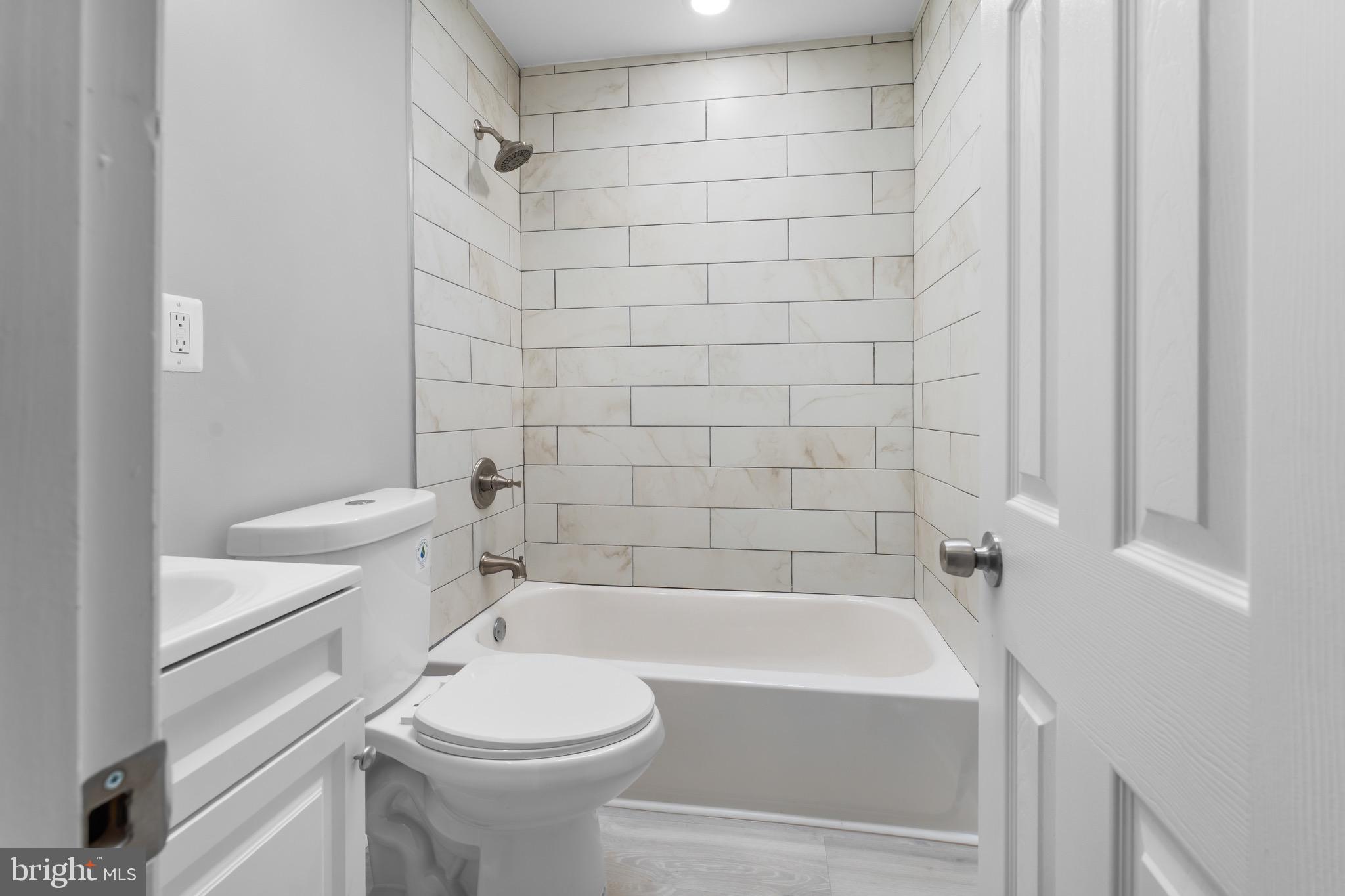 3904 Woodridge Road Baltimore, MD 21229 - Photo 9 of 17 a bathroom with a sink a toilet and shower