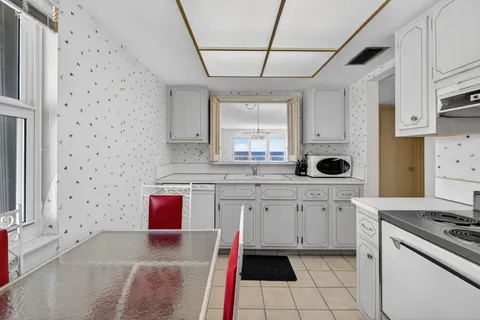 a kitchen with stainless steel appliances a stove a sink and a refrigerator