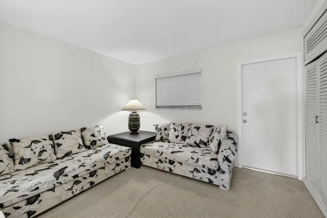 a bed room with furniture and a lamp