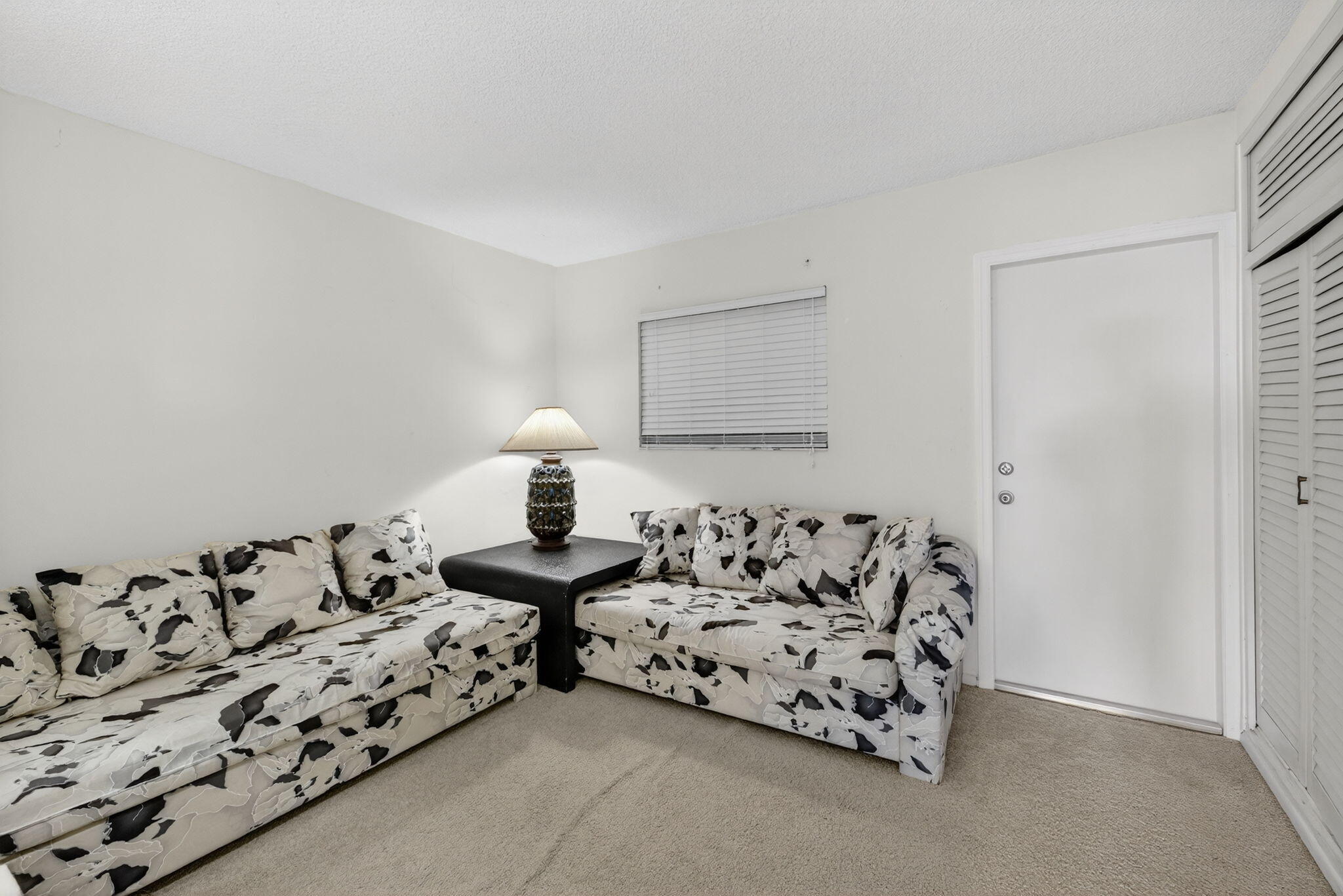 1069 Hillsboro Mile, Unit 802 Hillsboro Beach, FL 33062 - Photo 18 of 47 a bed room with furniture and a lamp