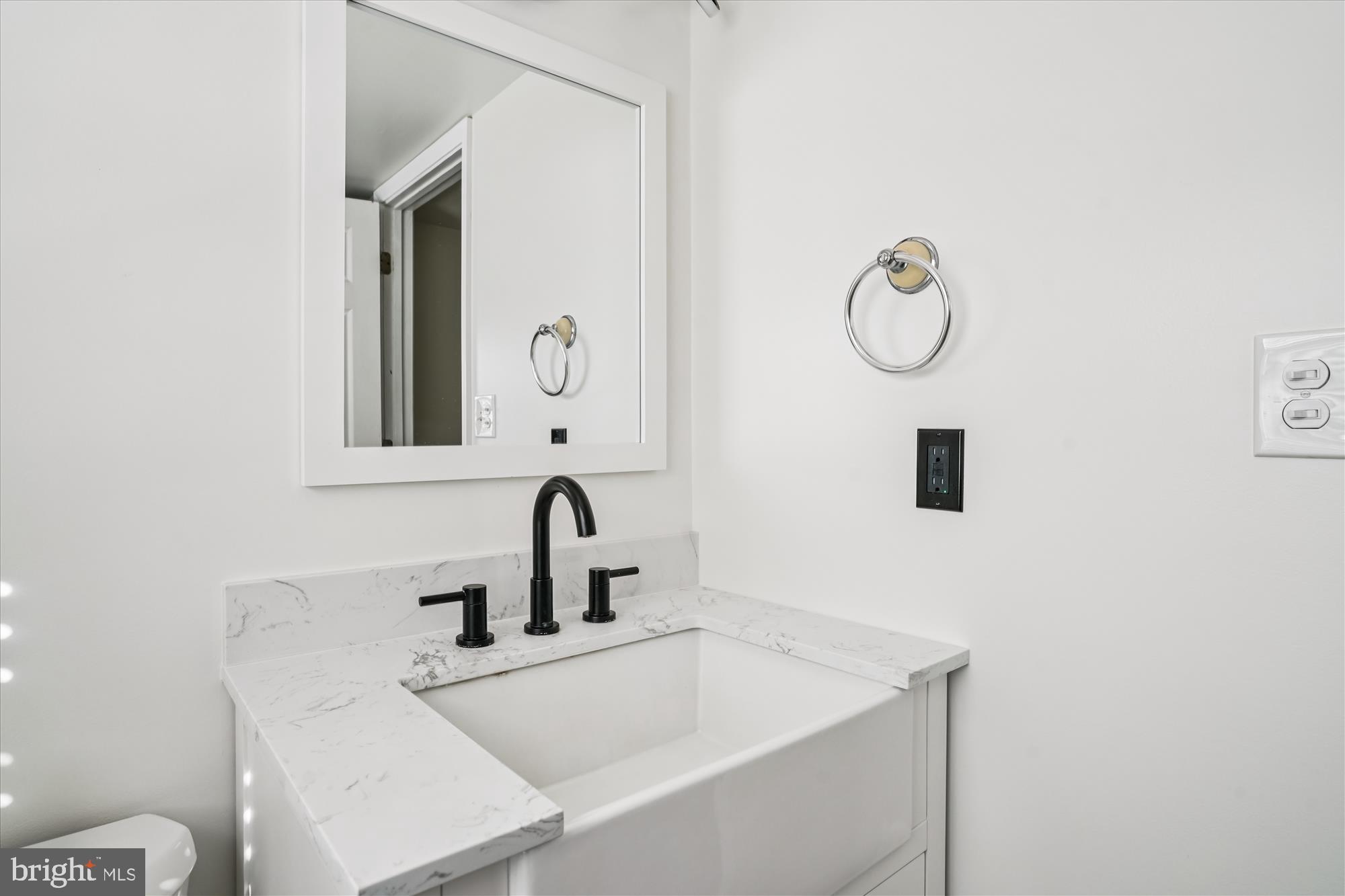 3831 8th Street North Beach, MD 20714 - Photo 14 of 37 a bathroom with a sink and a mirror