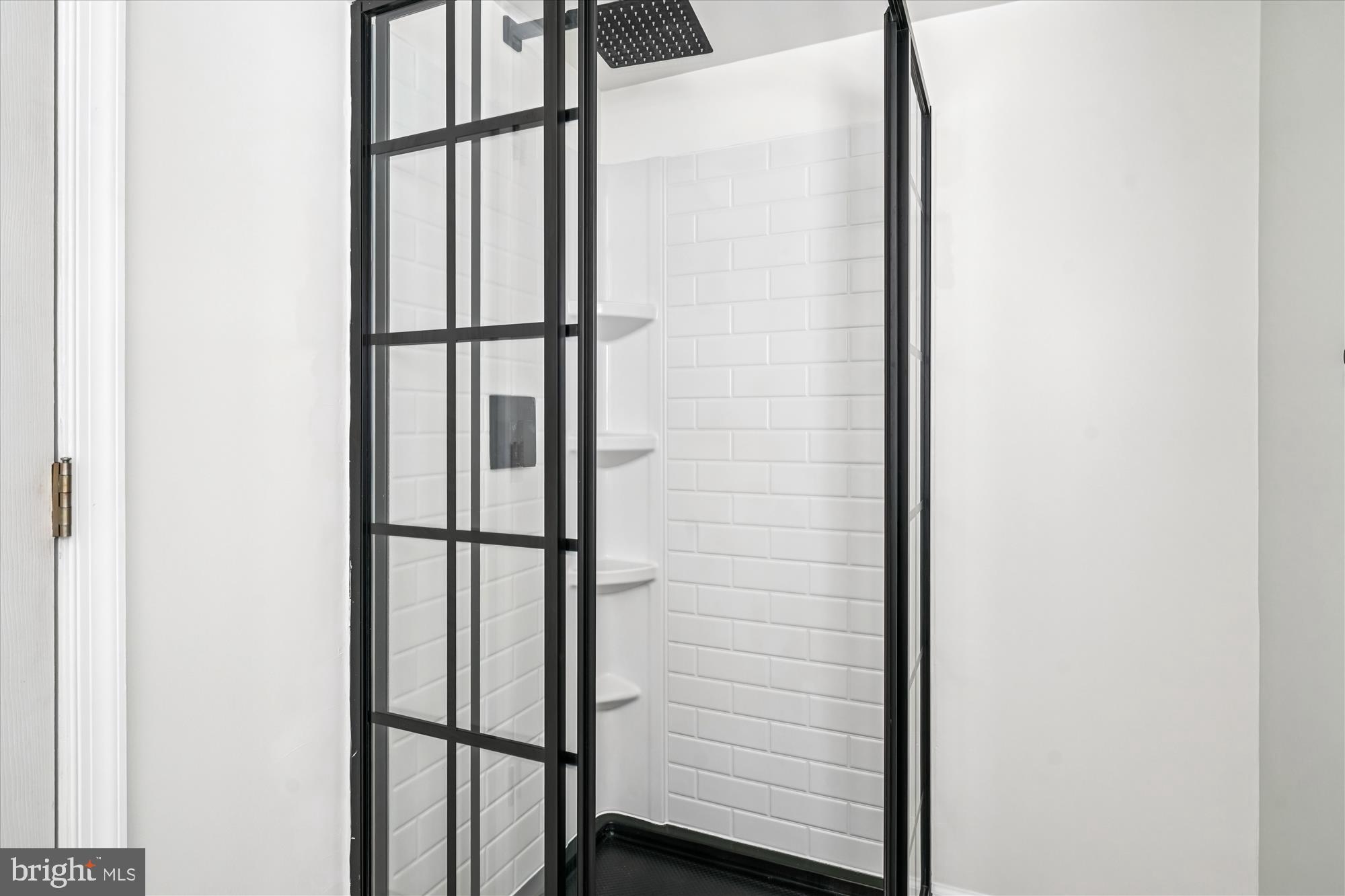 3831 8th Street North Beach, MD 20714 - Photo 16 of 37 a bathroom with a glass shower door