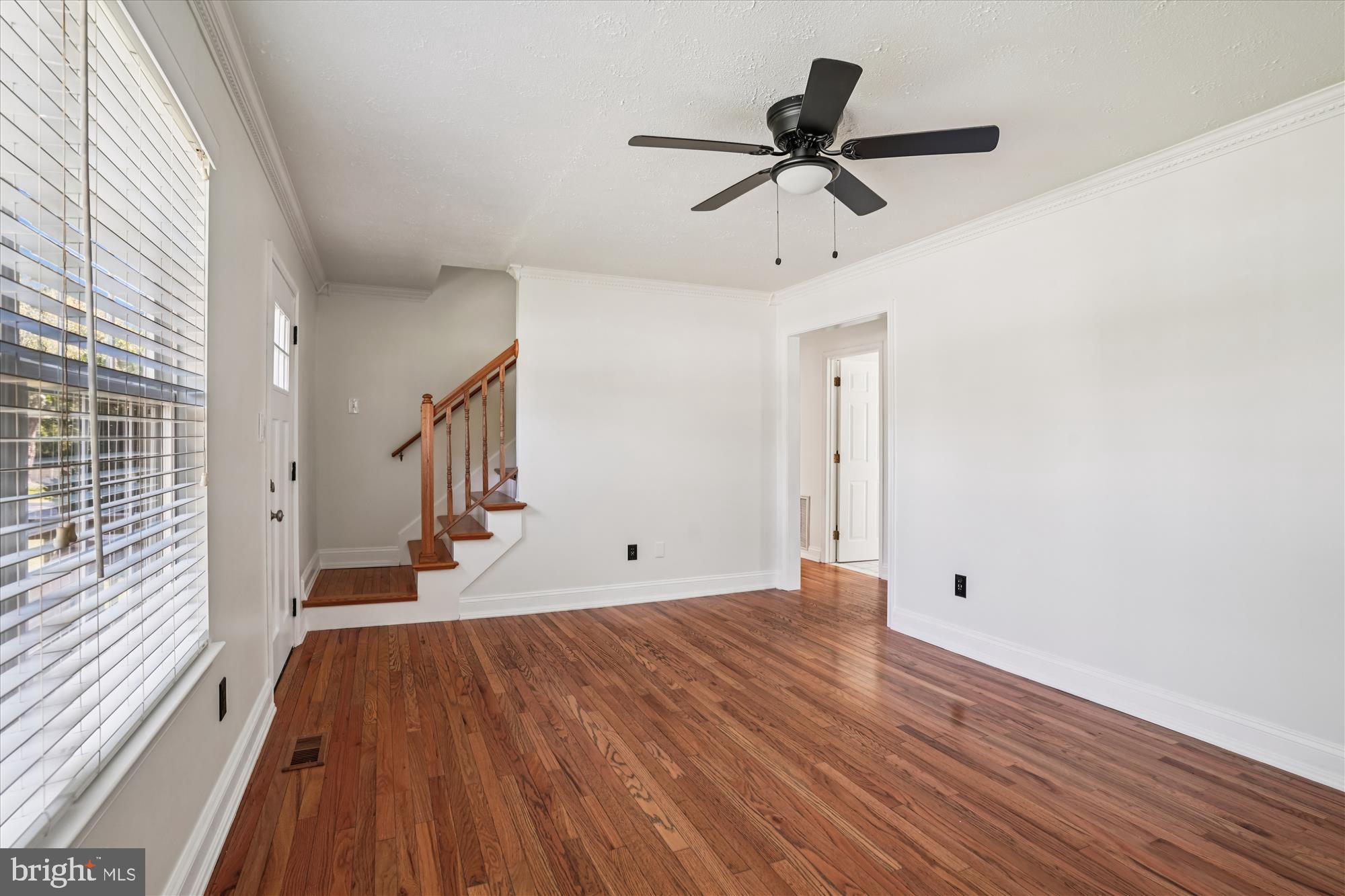 3831 8th Street North Beach, MD 20714 - Photo 2 of 37 a view of empty room with wooden floor and fan