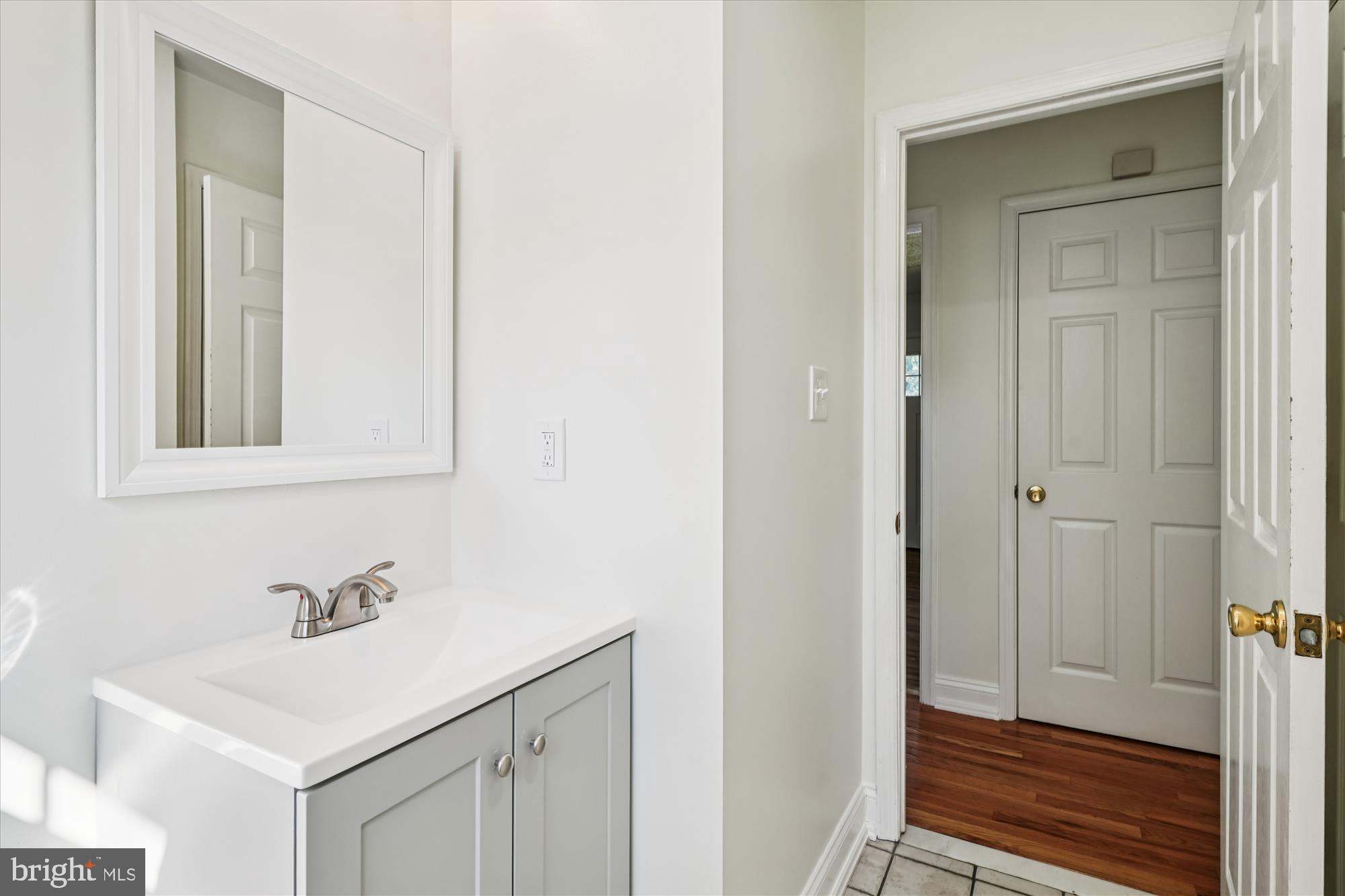 3831 8th Street North Beach, MD 20714 - Photo 21 of 37 a bathroom with a sink and a mirror