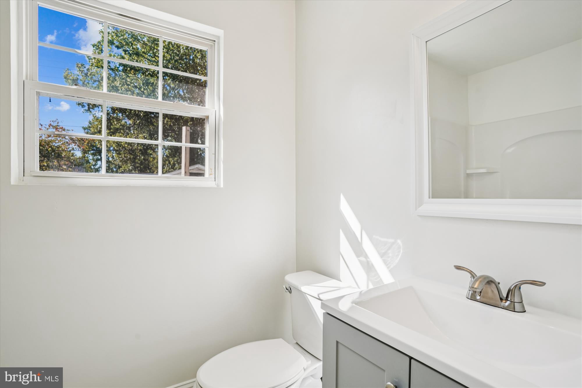 3831 8th Street North Beach, MD 20714 - Photo 23 of 37 a white toilet sitting next to a bathroom sink
