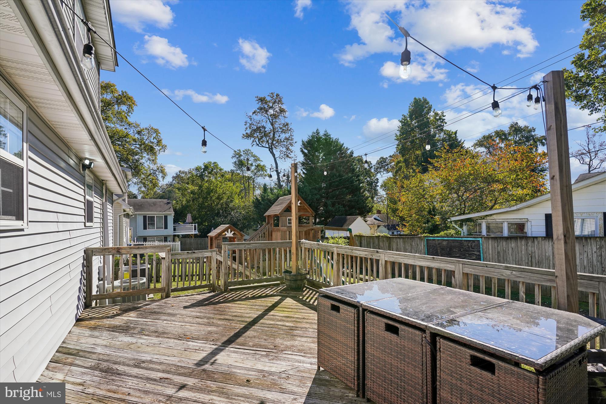 3831 8th Street North Beach, MD 20714 - Photo 24 of 37 a view of a deck with wooden floor and fence with a table