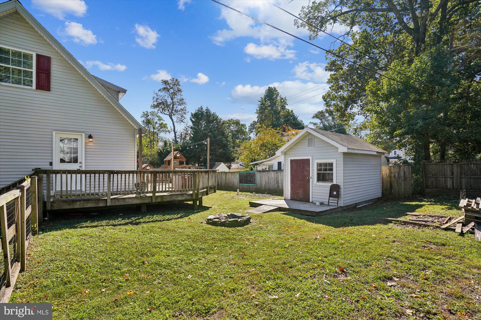 3831 8th Street North Beach, MD 20714 - Photo 25 of 37 a view of a house with wooden deck and a yard