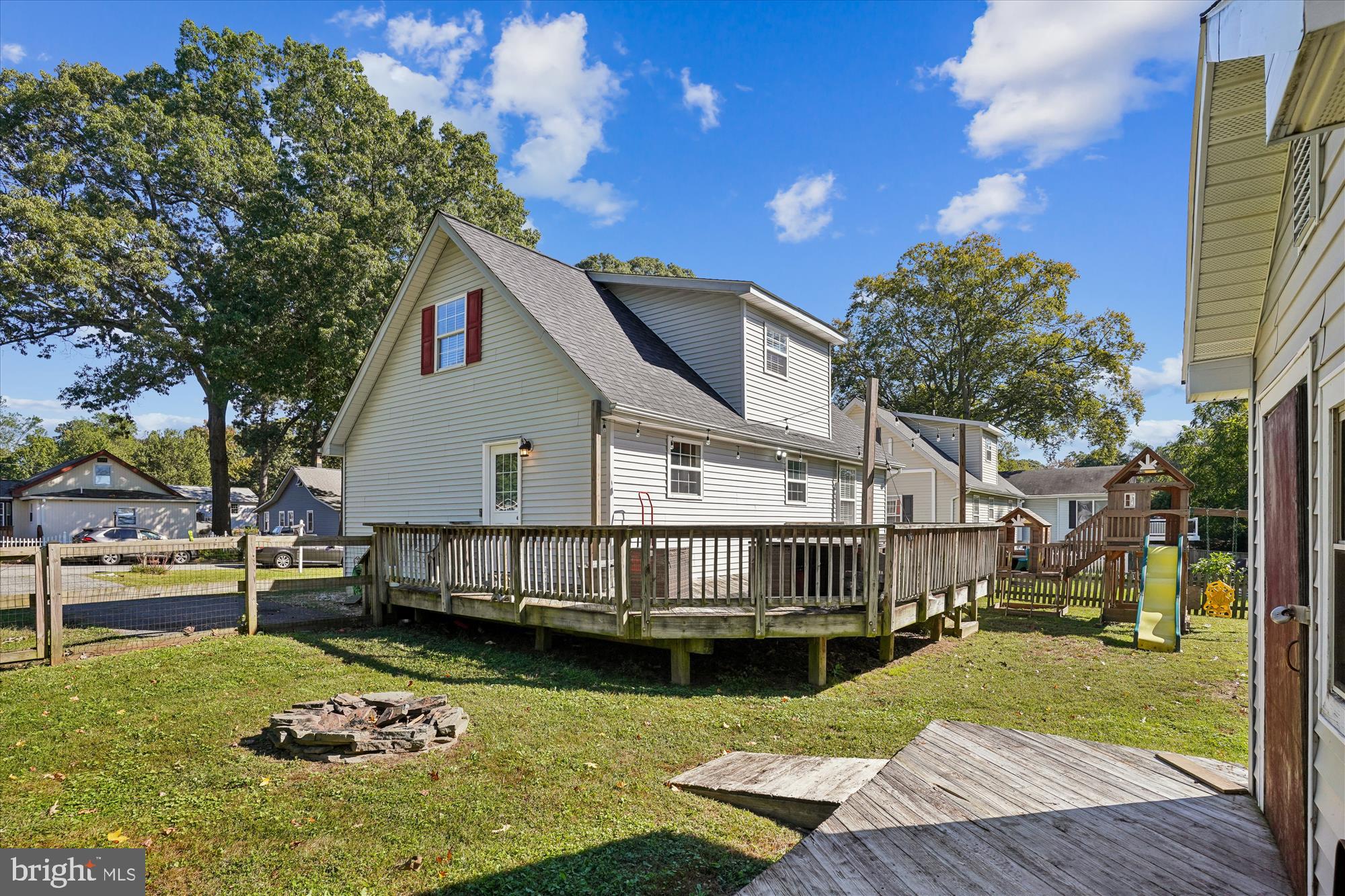 3831 8th Street North Beach, MD 20714 - Photo 28 of 37 a view of a house with a wooden deck